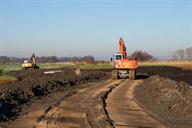 kranen leggen nieuwe waterkering aan